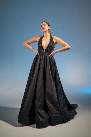 Luxurious ball gown with plunging halter neckline and hand-beaded bodice for an elegant look.