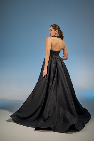 Voluminous maxi skirt and sleeveless design with intricate beading, perfect for formal events.
