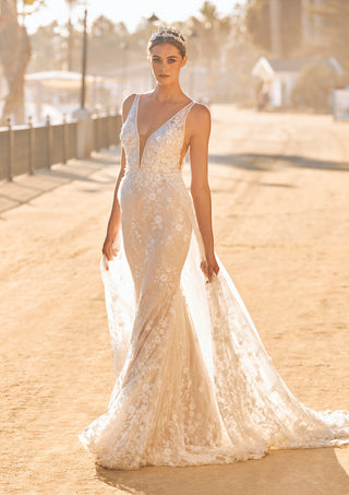 Mermaid bridal dress featuring plunging V-neck and beaded trim.