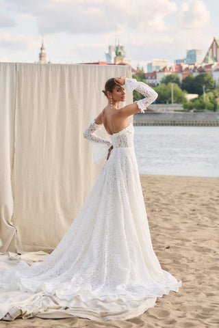 Mia Lavi luxury bridal creation in ivory lace with flared sleeves and couture detailing for an exclusive made-to-order experience