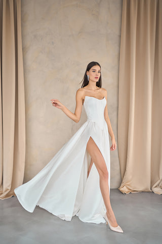 Luxurious A-line maxi skirt with a dramatic thigh-high slit and flowing draped design, perfect for elegant bridal moments.