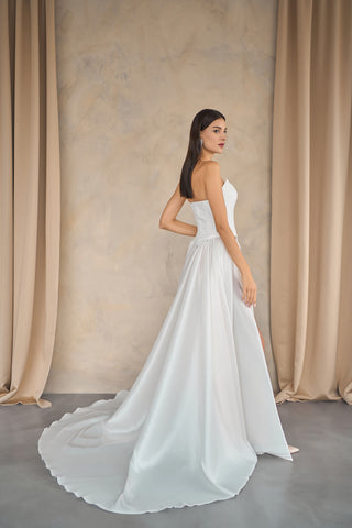 Sophisticated waterfall skirt with fluid cascading layers, accentuating movement and creating a statement bridal silhouette.