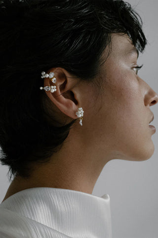 Intricate pearl clusters and pear-cut zirconia create a bold yet refined statement in luxurious gold vermeil