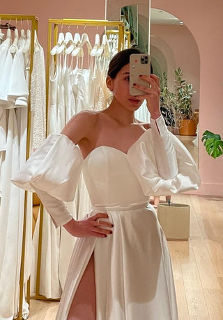 Luxurious A-line bridal gown with a strapless neckline, sleeveless design, and flowing satin silhouette tailored for elegance.