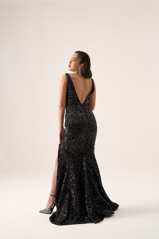 Formal sequin gown with a plunging neckline, fitted design, and dramatic slit, perfect for black-tie events.