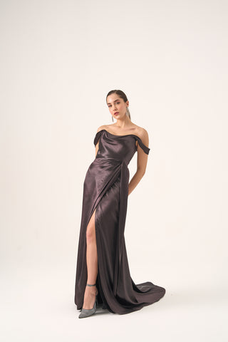 Off-the-shoulder satin gown with a draped bodice, thigh-high slit, and flowing A-line silhouette for formal occasions.