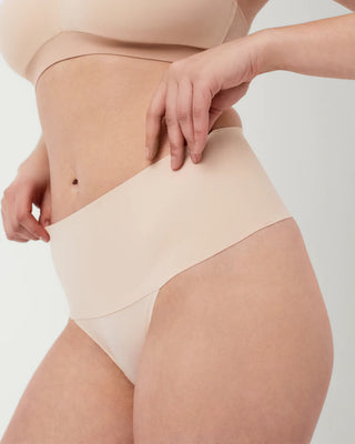Close-up of the Undie-tectable® Thong's waistband by Spanx, featuring bonded construction for added tummy flattening.