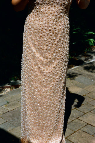 Maxi column gown featuring luxe sequin detailing and high halter neckline for a refined evening look