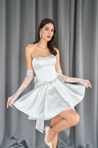 Chic strapless sweetheart neckline with structured A-line silhouette and playful oversized bow at the back.