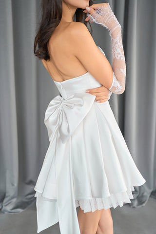 Tailored A-line mini dress with a romantic sweetheart neckline and playful back bow design.