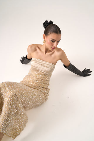 Body shot of the model in the Cristos beaded gown and black gloves, exuding timeless elegance.