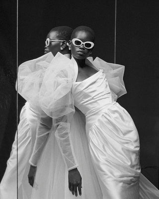 Front view of the Elizabeth Coat by Vivienne Westwood, showcasing the pleated sleeves, slim waist, and long ties that can be fastened at the front for an elegant bridal look.