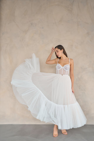 Custom-made tulle midi dress with a structured bodice, delicate spaghetti straps, and flowing A-line style for formal wear.