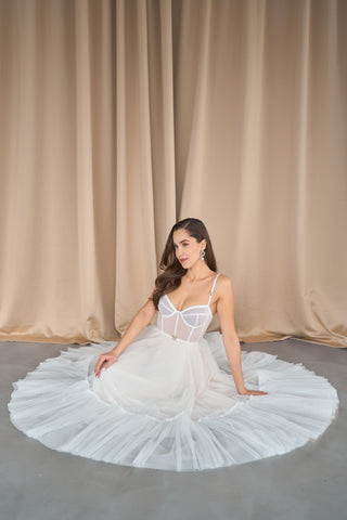 Tulle midi dress designed with a sweetheart neckline, structured bodice, and lightweight A-line finish for formal events.