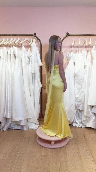 Sophisticated satin gown featuring a strapless neckline and daring slit, perfect for upscale events.