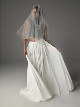 Model wearing the Calina Skirt by Pronovias in soft georgette fabric.