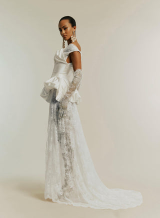 Side view of the Lace Minerva styled with the Raven corset in white, set against a plain white backdrop to emphasize the gown’s silhouette and details.