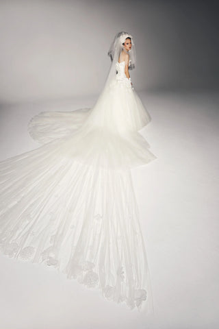 Viktor&Rolf couture bridal veil in ethereal tulle with artisanal organza flowers, a bespoke luxury accessory highlighting design heritage and exclusivity