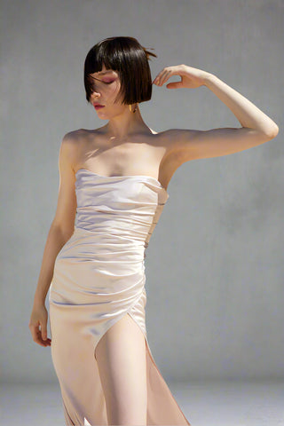 Chic strapless satin gown with a sleek corseted fit and high slit, perfect for high-end formal events and glamorous evenings.