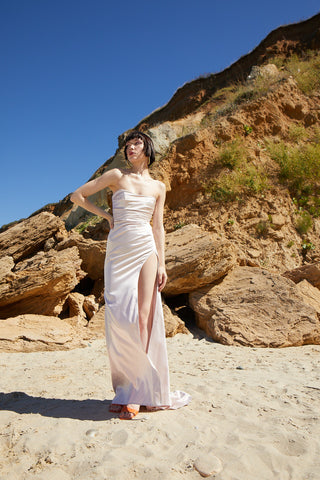 Elegant satin maxi gown with a straight neckline, corset bodice, and daring thigh-high slit for a sophisticated touch.