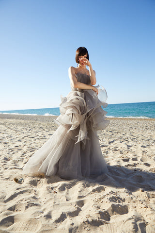 Elegant strapless evening gown with a dramatic full skirt and layered organza design, creating a timeless and sophisticated look.