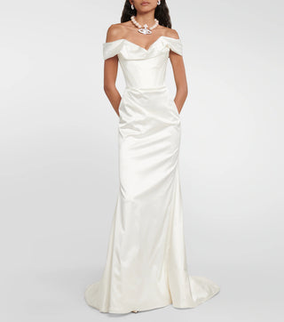 Front view of a model in the Nova Cora gown styled with a pearl necklace.