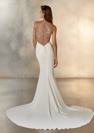 Modern crepe wedding dress with sleeveless silhouette and clean lines.