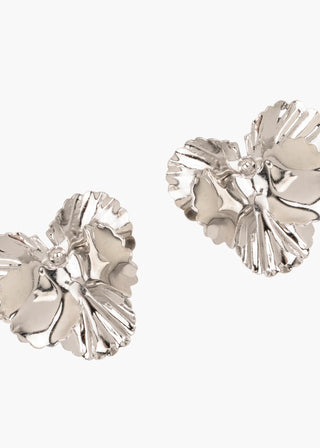 Pair of silver floral earrings on a white background