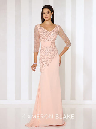 Sheath evening gown with shimmering embroidered bodice, deep V-neckline, and sheer three-quarter sleeves
