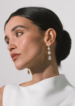 Elegant linear earrings with pear-cut crystal accents and graduated pearl detailing