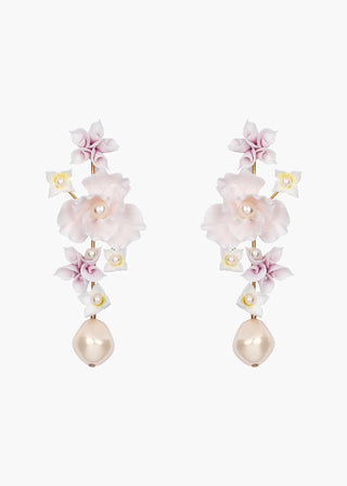 Handcrafted statement earrings with sculpted floral details and a gracefully swaying pearl drop, embodying luxury and elegance.