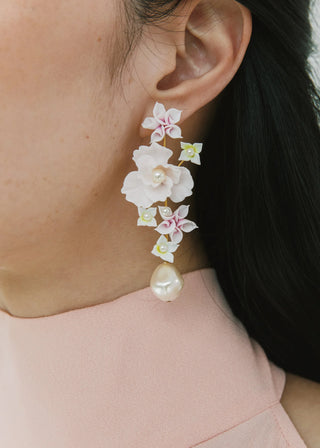 High-fashion earrings featuring poetic floral artistry and a fluid pearl drop, embodying artisanal craftsmanship and luxury design.