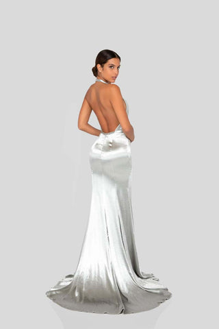 Designer maxi evening dress featuring a wrap silhouette, halter straps, body-skimming drape, and dramatic slit for red-carpet elegance