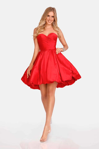 Woman wearing a red strapless dress on a white background