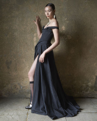 Side view of the Tabitha gown in black, showcasing the gown’s draped design and sleek silhouette.