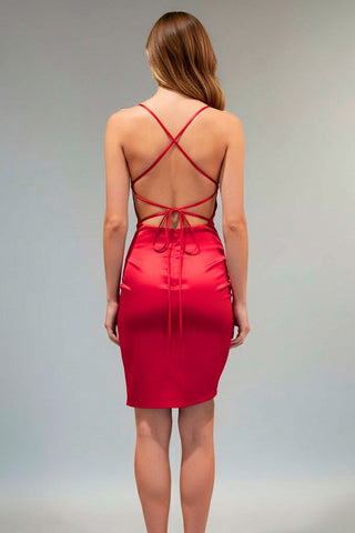 Red dress with criss-cross back design on a plain background