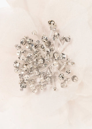 Artisanal barrette clip featuring sculptural floral silhouette with beaded texture and soft volume