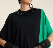 Sophisticated evening set with a caftan-style top, bead accents, crew neckline, and graceful cape sleeves paired with tailored pants.