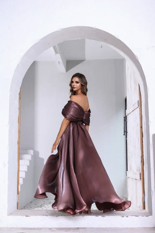 Woman in a long, flowing dress standing in an archway.
