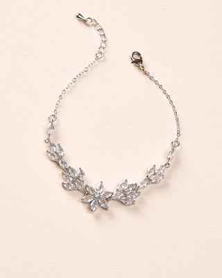 Silver necklace with floral design on a beige background