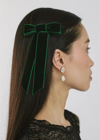 Side view of model with Velvet Bow Barrette in Emerald – elegant and bold hair accessory