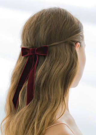 Model wearing Velvet Bow Barrette in Pinot – bold and elegant hair accessory