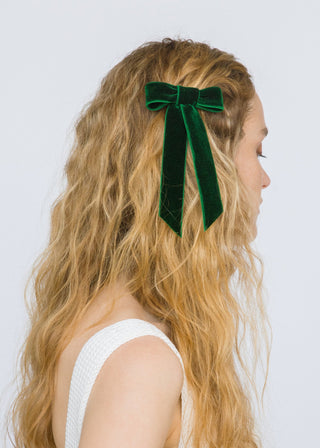 Model wearing Velvet Bow Barrette in Emerald – adds a pop of color to any hairstyle