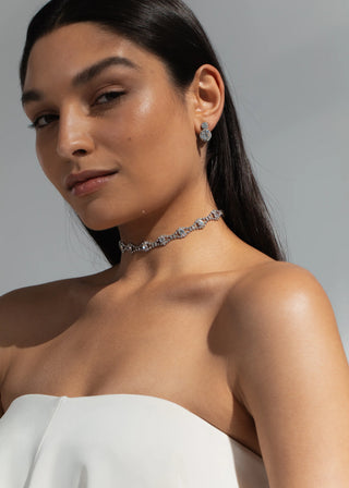 Model wearing Rosita Ribbon Tie in Crystal around the neck – sophisticated silk and crystal accessory for a glamorous touch