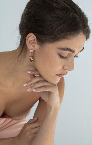 Model with hair up wearing Justine earrings, highlighting the luxurious antique rose design.