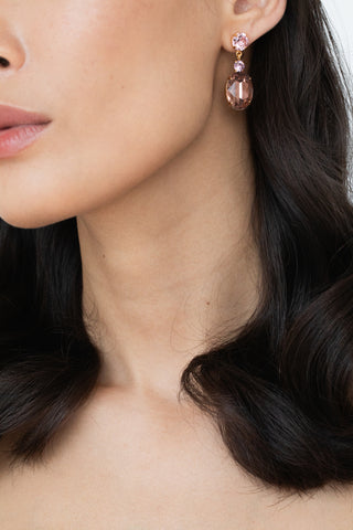 Model wearing Justine earrings with hair down, showcasing elegant emerald-cut crystal drops.