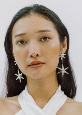 Model wearing Estee Earrings with hair down – star-shaped earrings adding a touch of sparkle to a casual chic look