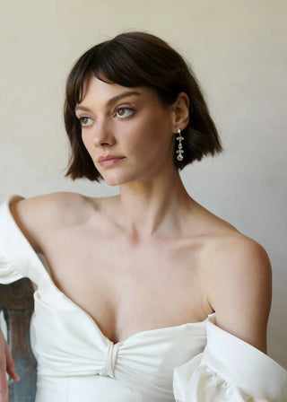 Luxury statement earrings featuring pear and round-cut crystal mosaic in refined linear design