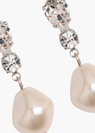 Pearl and crystal drop earrings on a white background