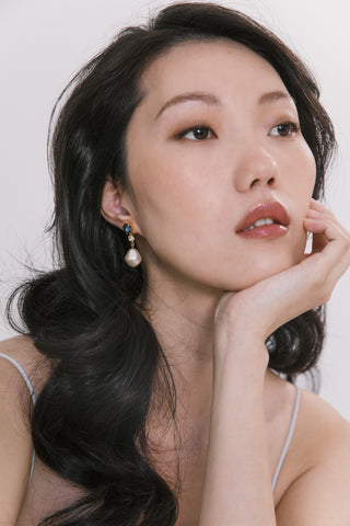 Handcrafted designer earrings showcasing a stunning crystal cluster and luminous baroque-style drop pearl